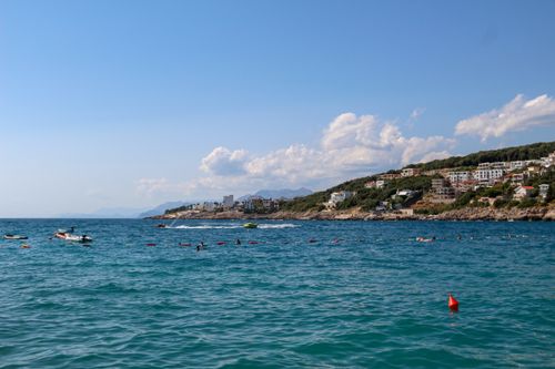 Free Stunning view of turquoise sea meeting rugged cliffs under a clear blue sky, perfect summer getaway. Stock Photo