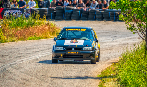Free Thrilling rally car race on a sunny day in Ριτσώνα, Greece, with a large audience watching. Stock Photo