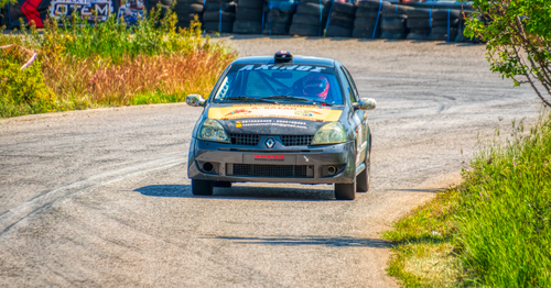 Free Thrilling car race along a winding track in Ritsona, Greece, showcasing speed and excitement. Stock Photo