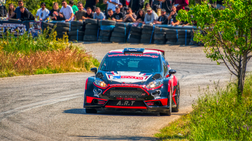 Free Rally car in action at a vibrant racing event in Ritsona, Greece. Spectators watching enthusiastically. Stock Photo