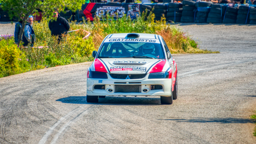 Free A rally car speeds on a winding track during a motorsport event in Ritsona, Greece. Stock Photo