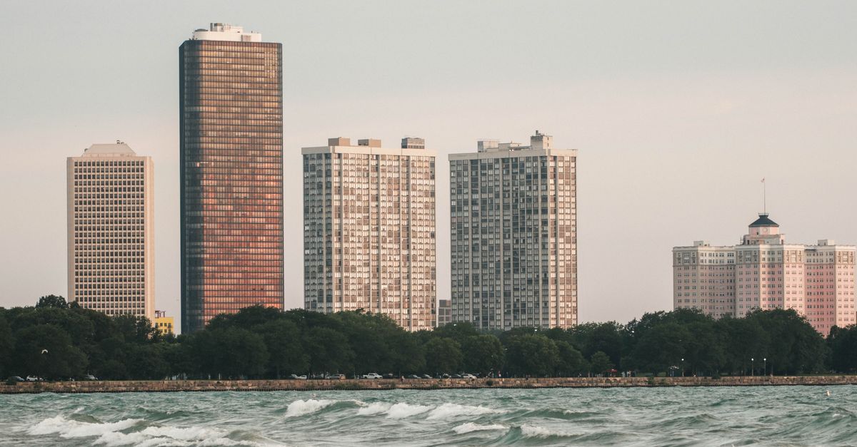 High-rise buildings along Lake Michigan in Chicago with a calm wave foreground.