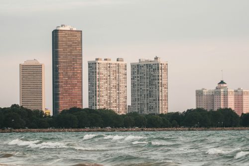 Free High-rise buildings along Lake Michigan in Chicago with a calm wave foreground. Stock Photo