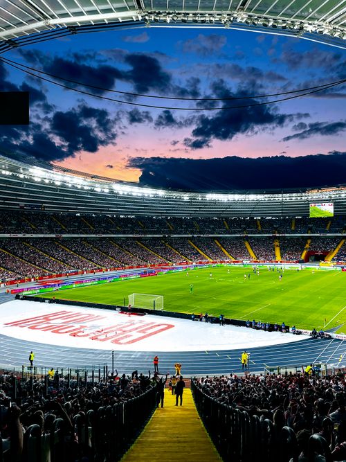 Free Exciting evening football match at Silesia Stadium in Katowice, Poland with a lively crowd. Stock Photo
