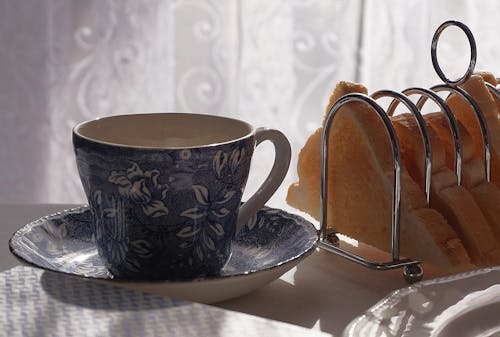 Porcelain Teacup and Saucer and Toasted Bread Slices