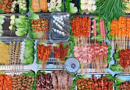 Colorful skewers of meats and vegetables at a Chengdu street market, perfect for food enthusiasts.