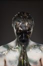Male model with body art and hands in pray gesture