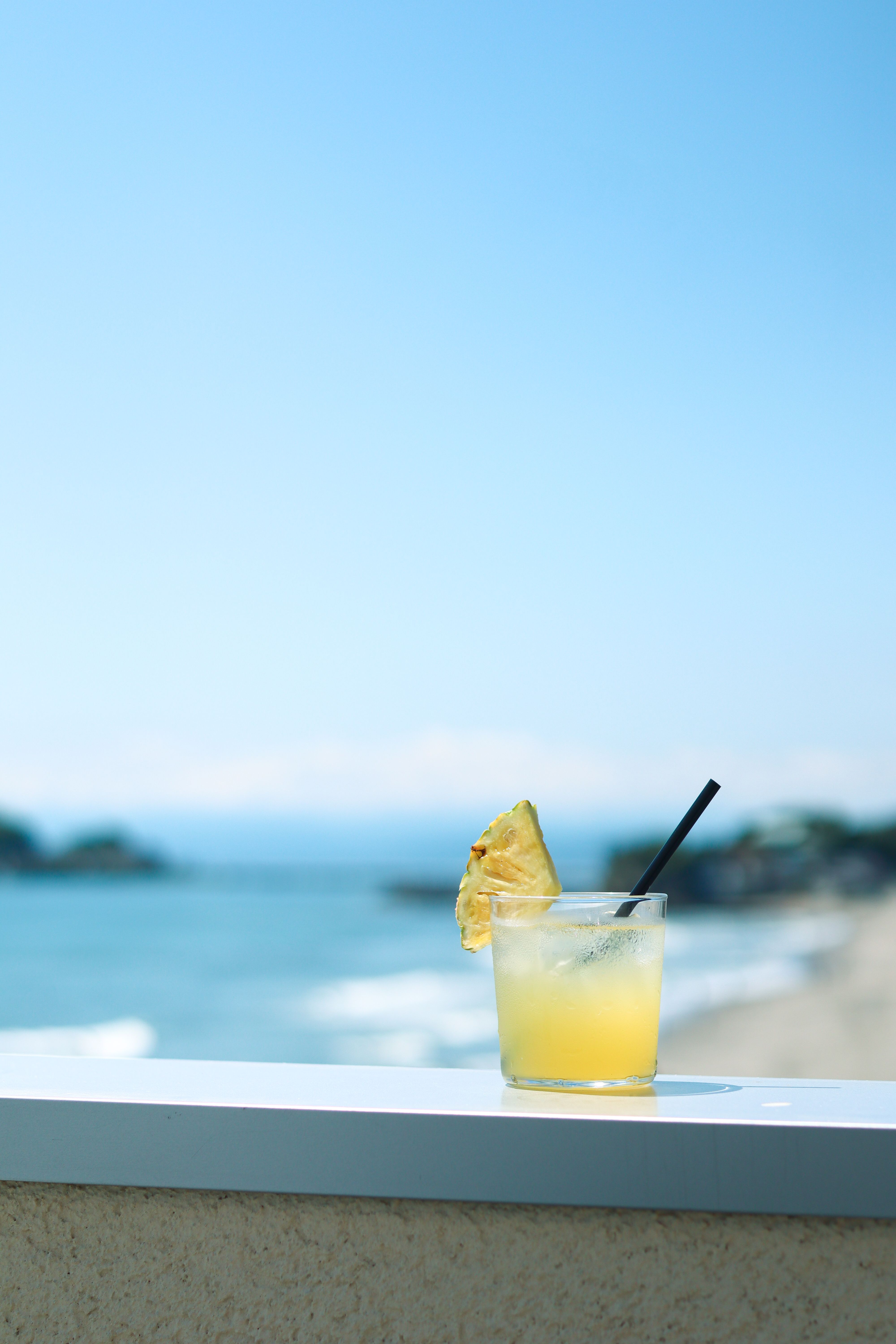 A tropical pineapple cocktail with an ocean view in Japan.