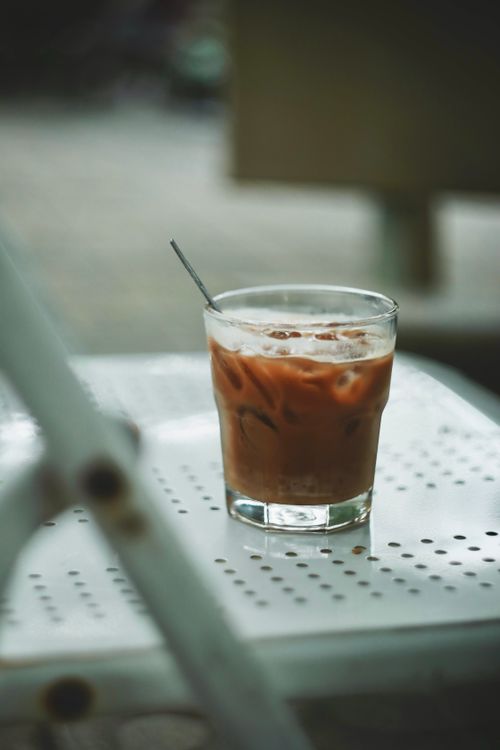 Free Refreshing iced coffee served on a metal table, perfect for summer. Stock Photo