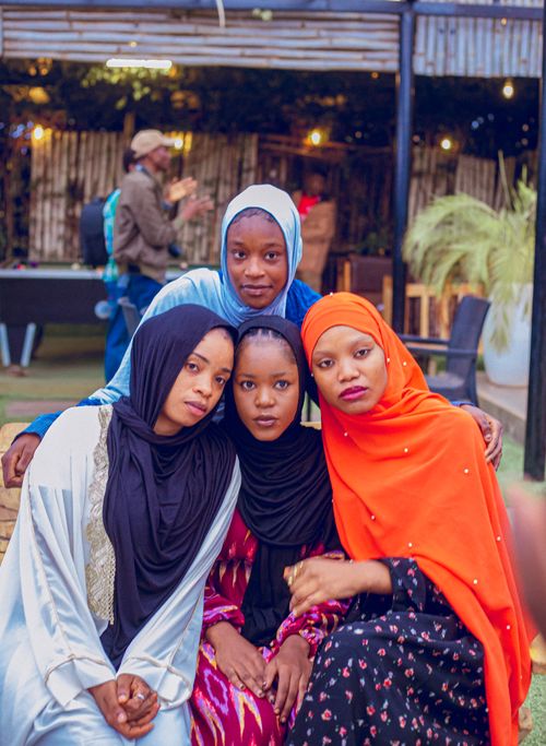Free Four women wearing hijabs pose together in an outdoor setting, showcasing cultural diversity and friendship. Stock Photo