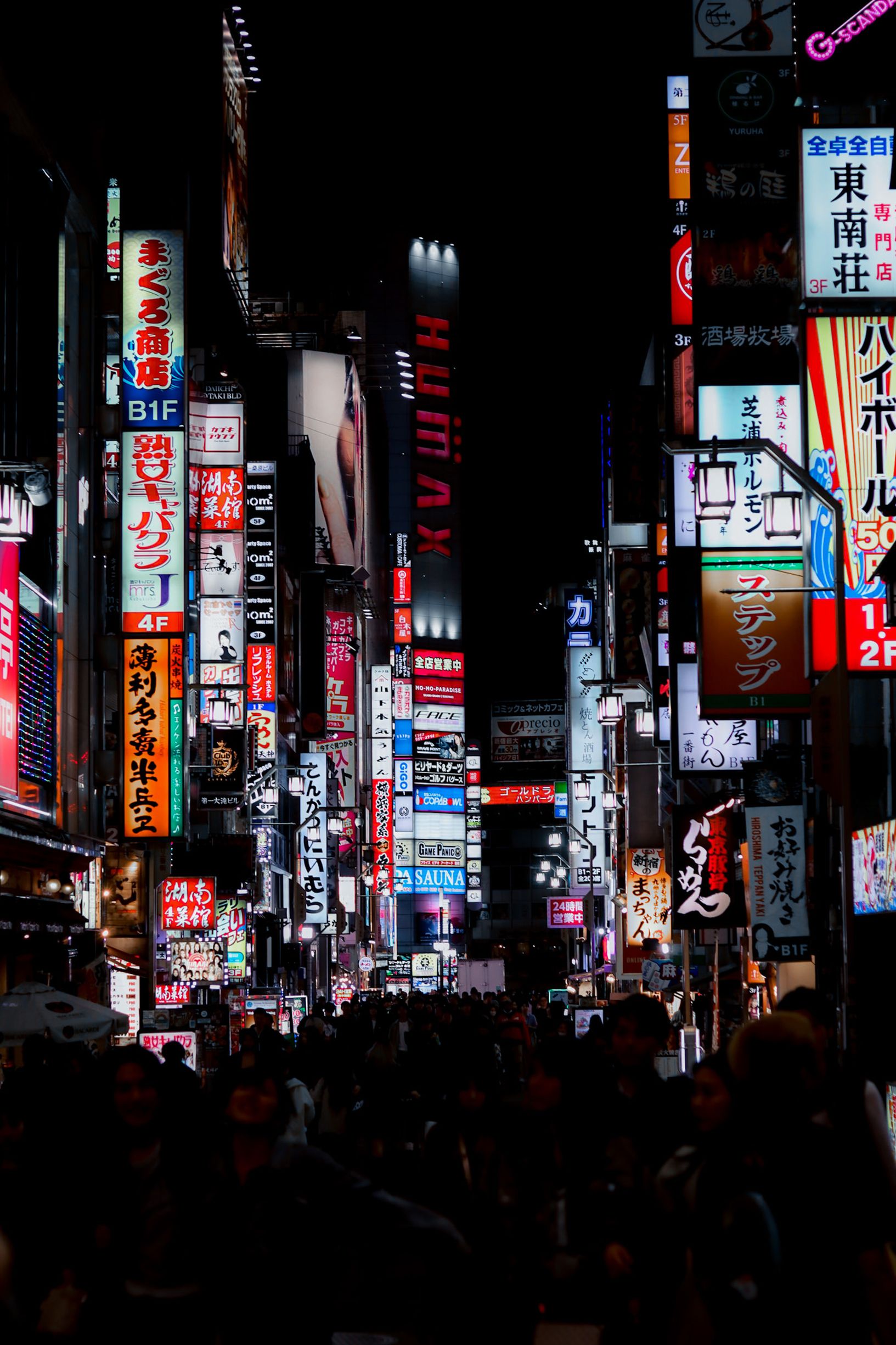 Captivating view of Shinjuku's neon lights and bustling nightlife in Tokyo, Japan.
