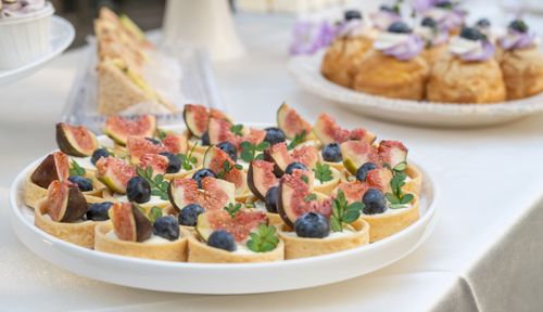 Free A close-up of assorted pastries topped with figs and blueberries, perfect for dessert tables or events. Stock Photo