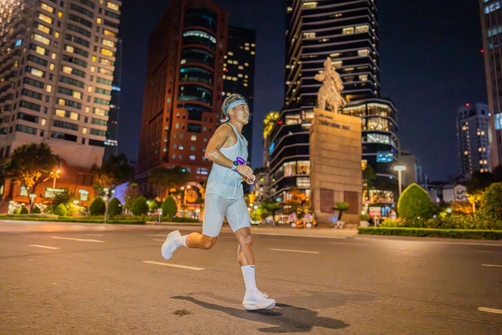 A runner crossing an empty city intersection late at night — photo by VANNGO Ng on Pexels