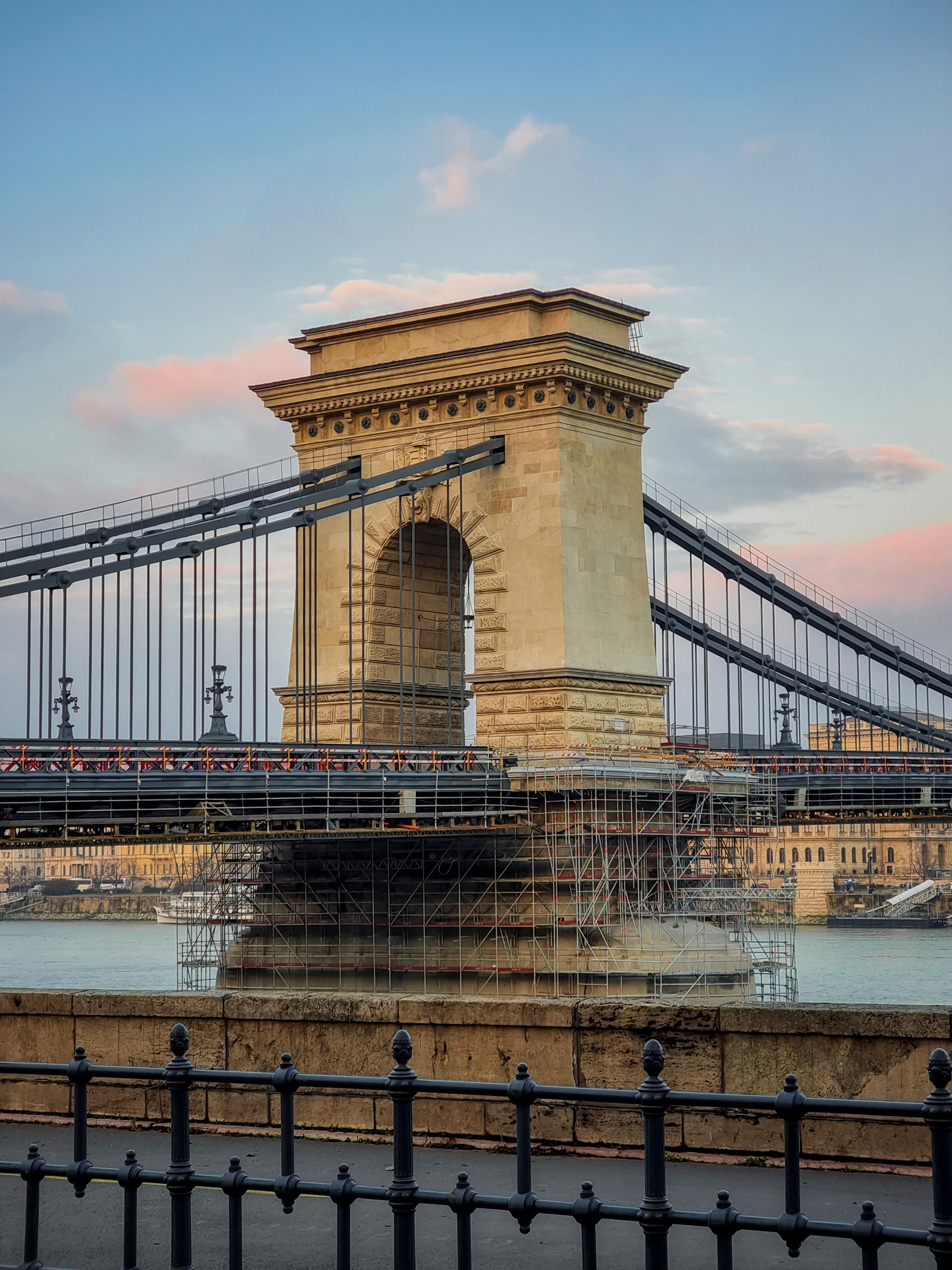 Iconic Chain Bridge over the Danube River in Budapest during sunset, showcasing its grandeur.