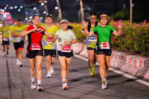 Free Dynamic image of marathon participants running outdoors at night, showcasing endurance and joy. Stock Photo