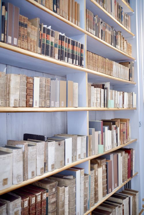 Free Bookshelf filled with vintage books at a library in Weimar, Germany, showcasing classic literature. Stock Photo