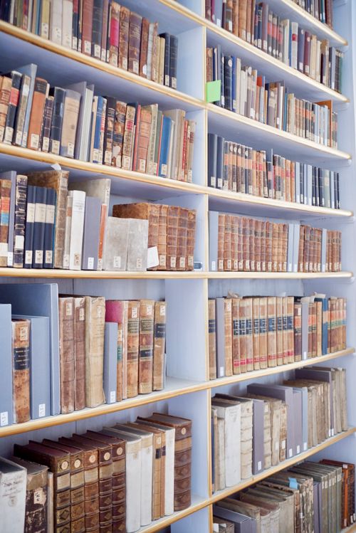 Free A collection of vintage books on a wooden shelf in a Weimar, Germany library. Stock Photo