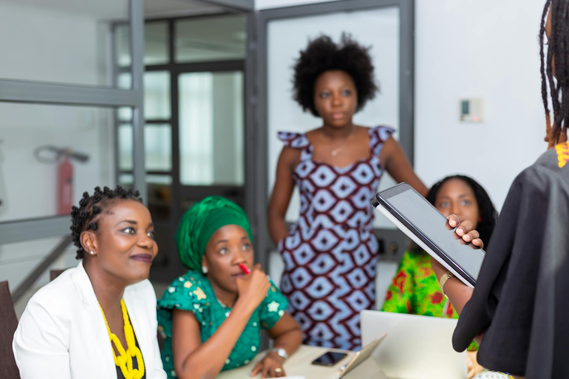 Diverse team of African women collaborating in an office meeting.