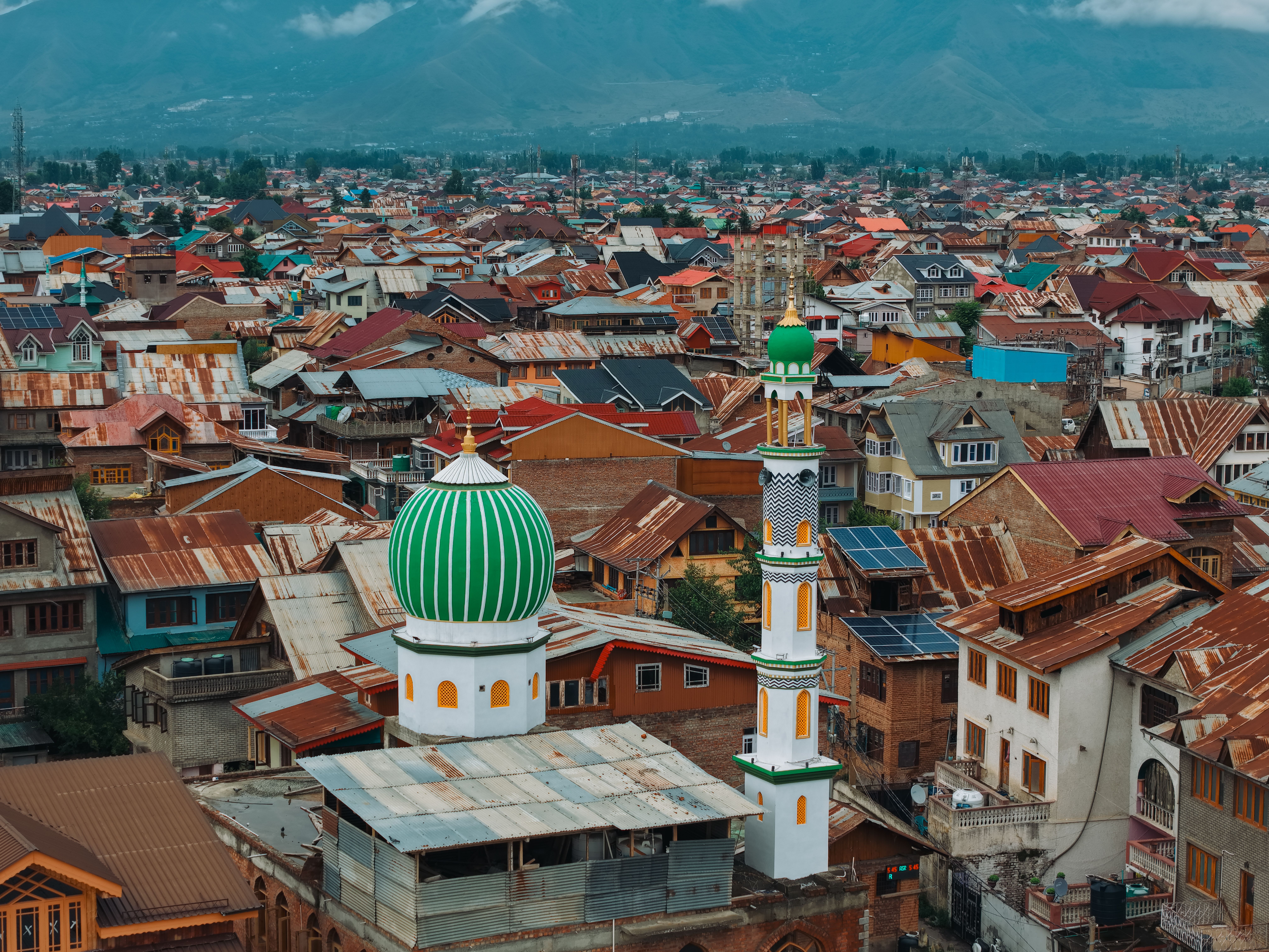 A stunning aerial view of a mosque amidst the vibrant rooftops of Srinagar, Kashmir.