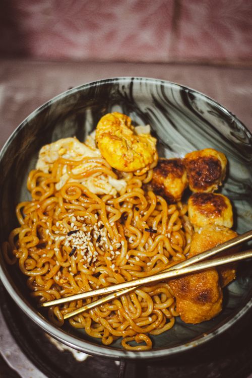 Bowl of spicy noodles with egg and dumplings — Tanha Tamanna Syed on Pexels
