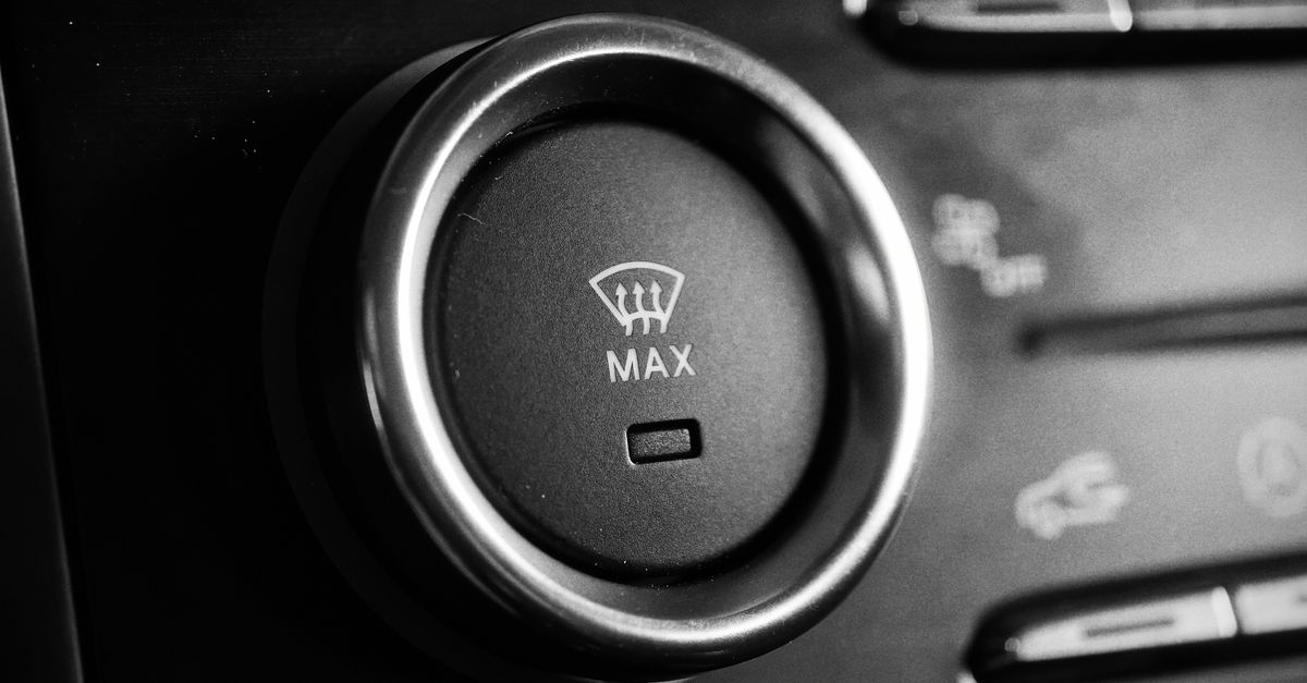 Detailed close-up of a car climate control knob in black and white, captured for automotive enthusiasts.