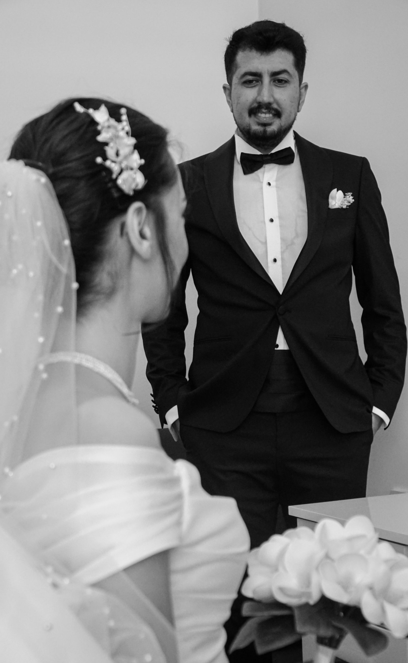 Bride and groom captured in a classic black and white wedding portrait.