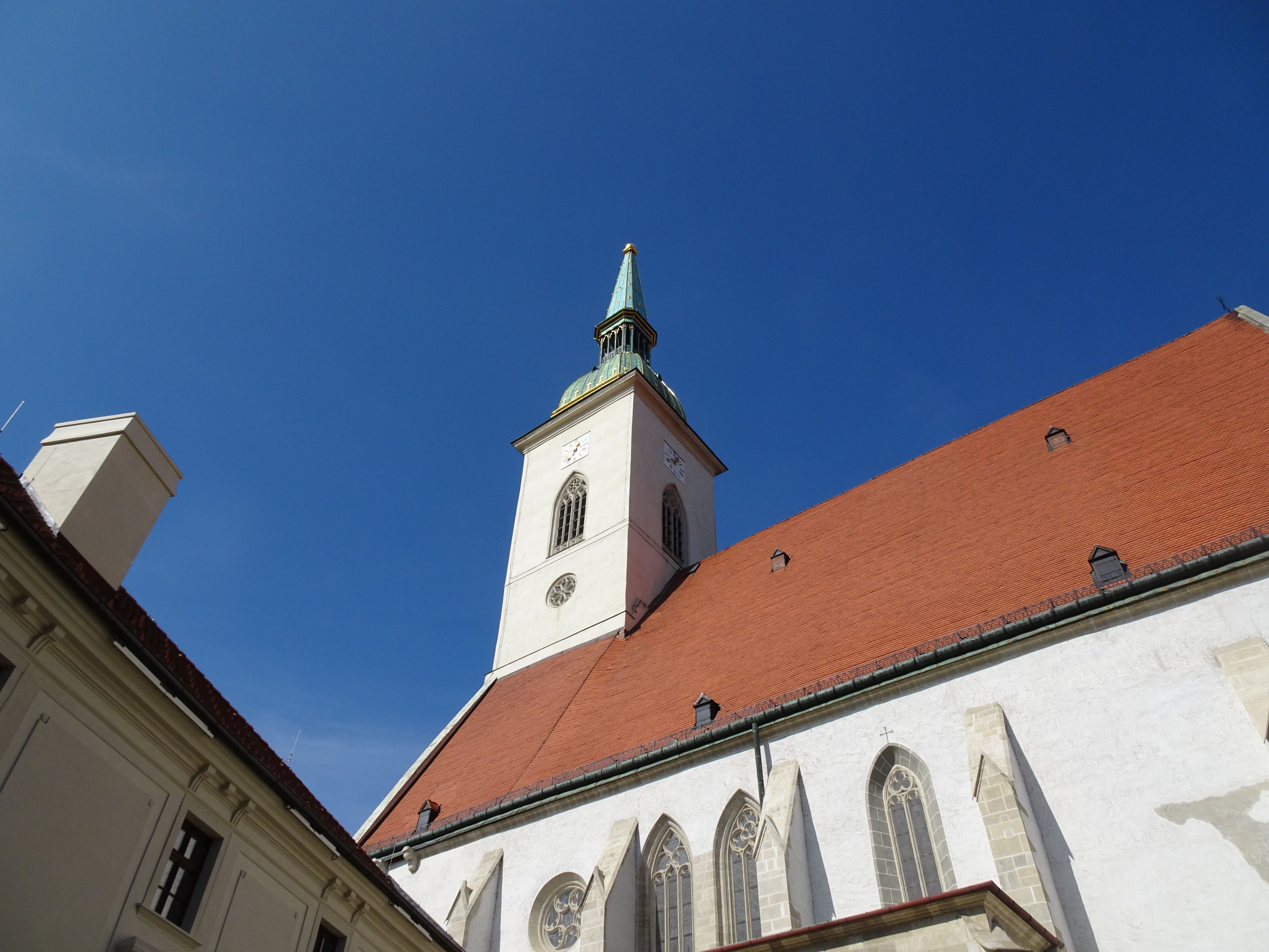 St. Martin's Cathedral in Bratislava, Slovakia with its distinct tower standing against a clear blue sky.