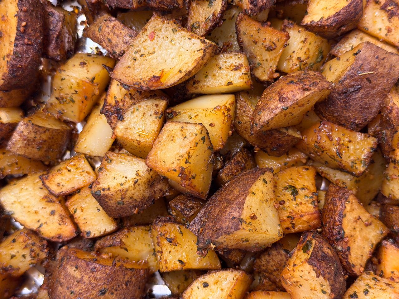 Close-up of seasoned roasted potato cubes