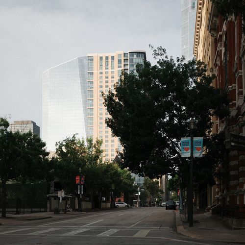 Free View of downtown with modern skyscrapers and lush greenery, capturing city life. Stock Photo