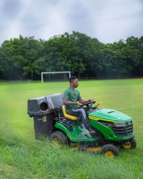 Mowing grass on a green field showing precise care