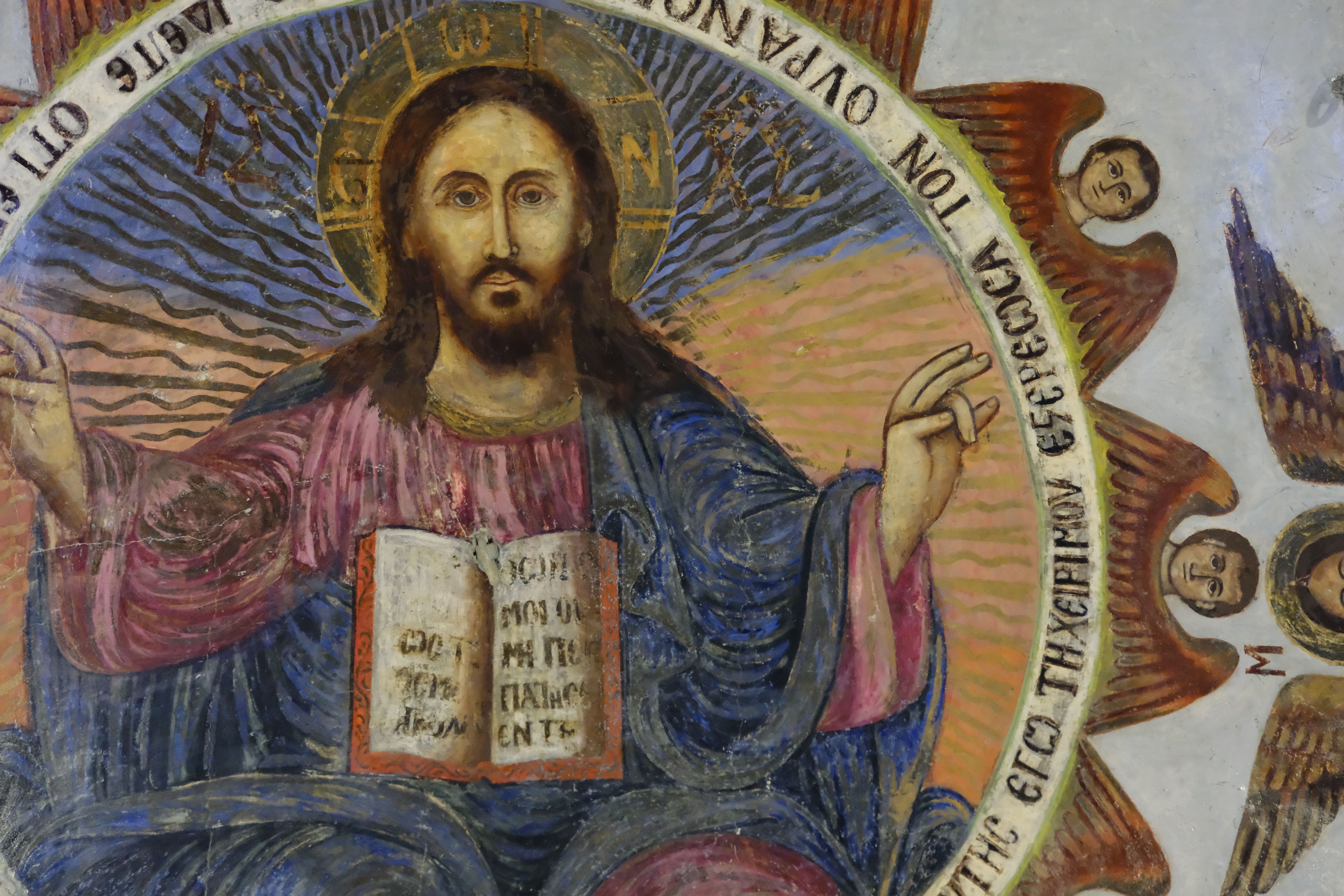 Intricate mural depicting a religious figure with angels, rich in historical symbolism and artistry.