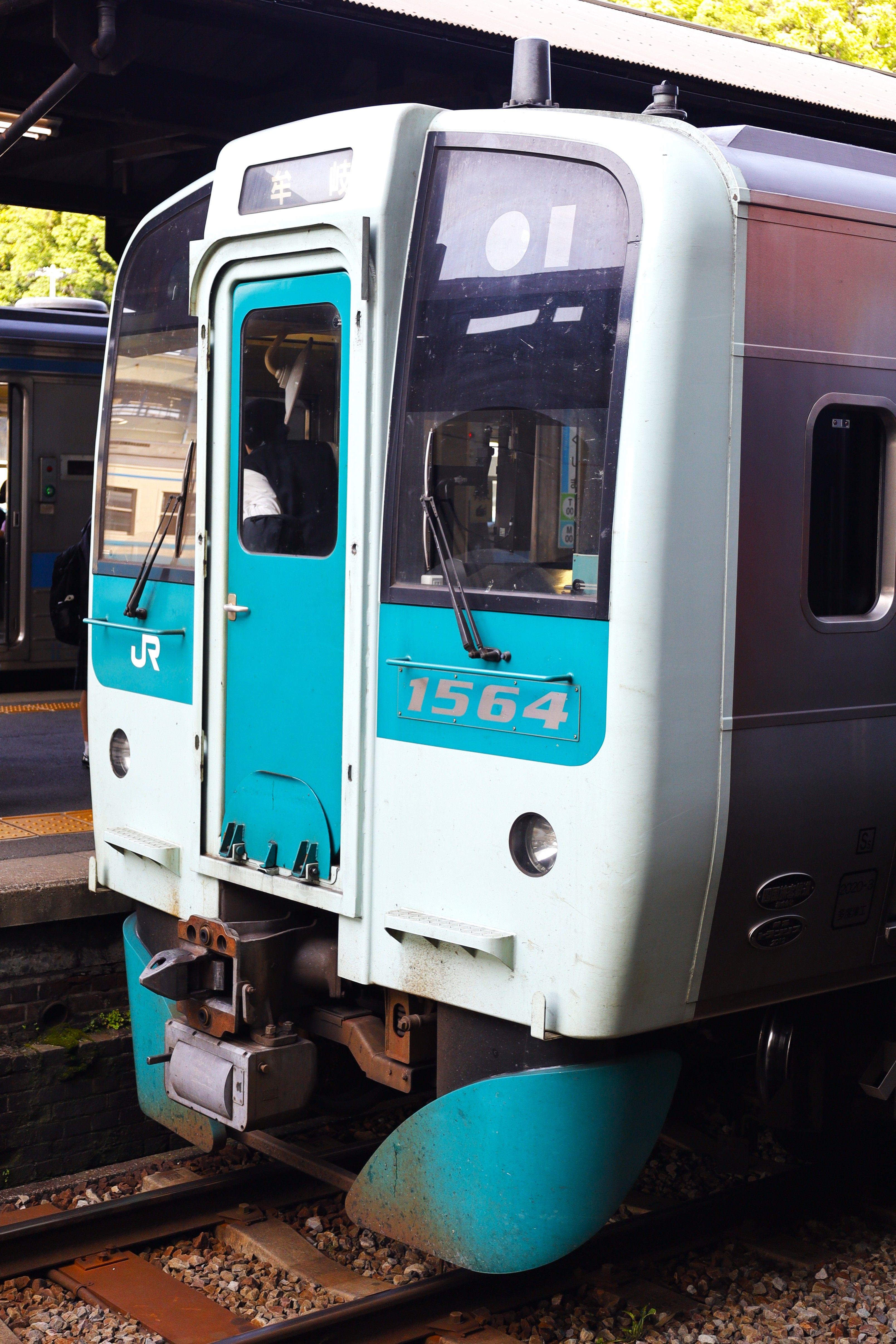 A local commuter train at the platform in Tokushima, showcasing Japan's efficient rail system.
