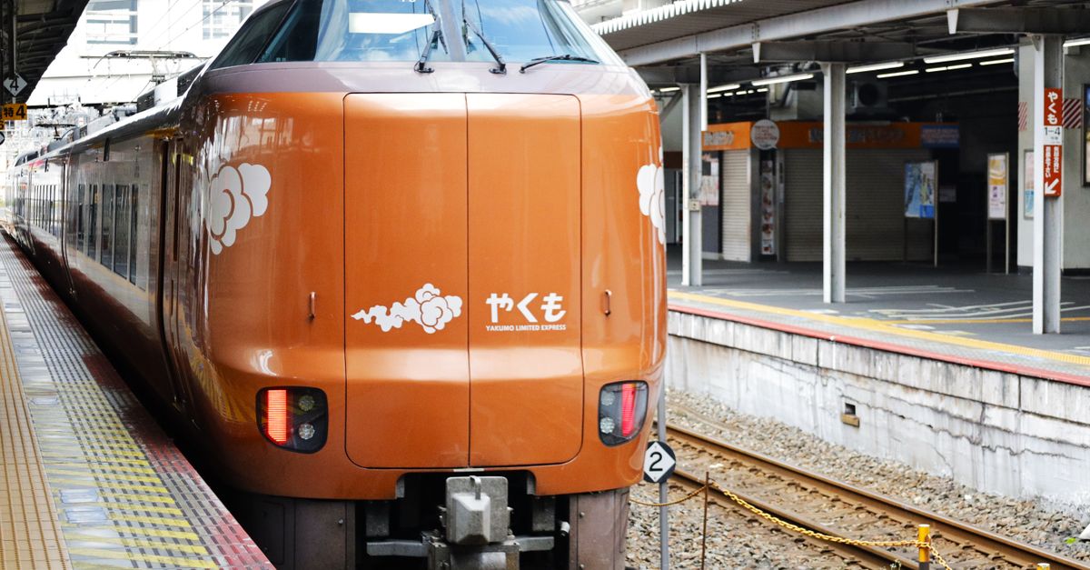 Yakumo Limited Express train stopped at a platform in Okayama Station, Japan.