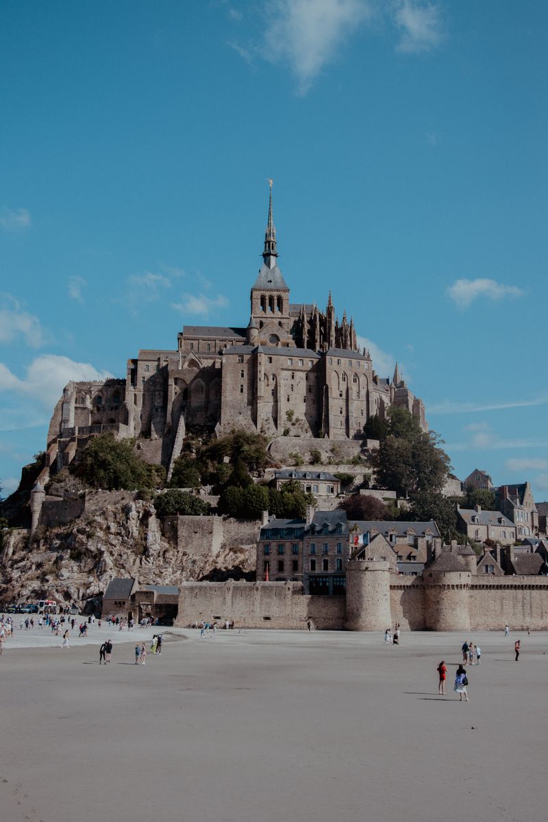 Mont-Saint-Michel abbey rising from the tidal bay in Normandy under a dramatic sky