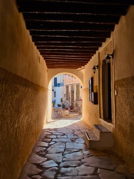 Picturesque stone alleyway with rustic architecture in a Mediterranean setting.