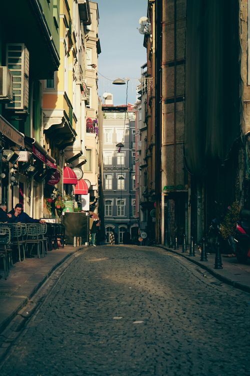 Free Charming European street lined with cafes and colorful architecture, exuding a cozy atmosphere. Stock Photo