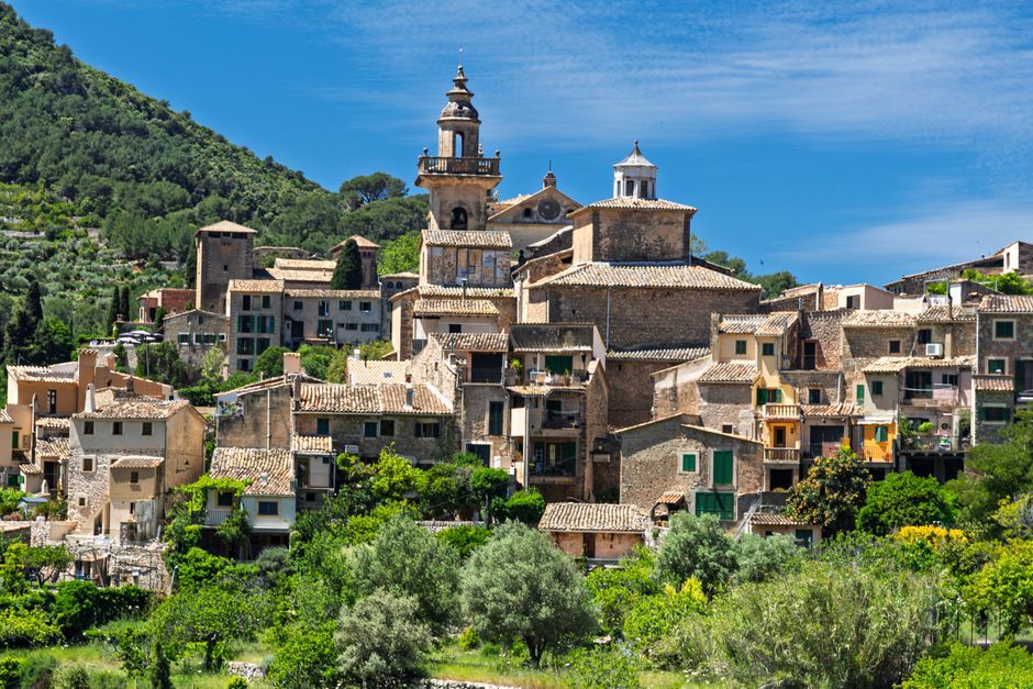 Picturesque village of Valldemossa in Mallorca with historical architecture and lush landscapes.
