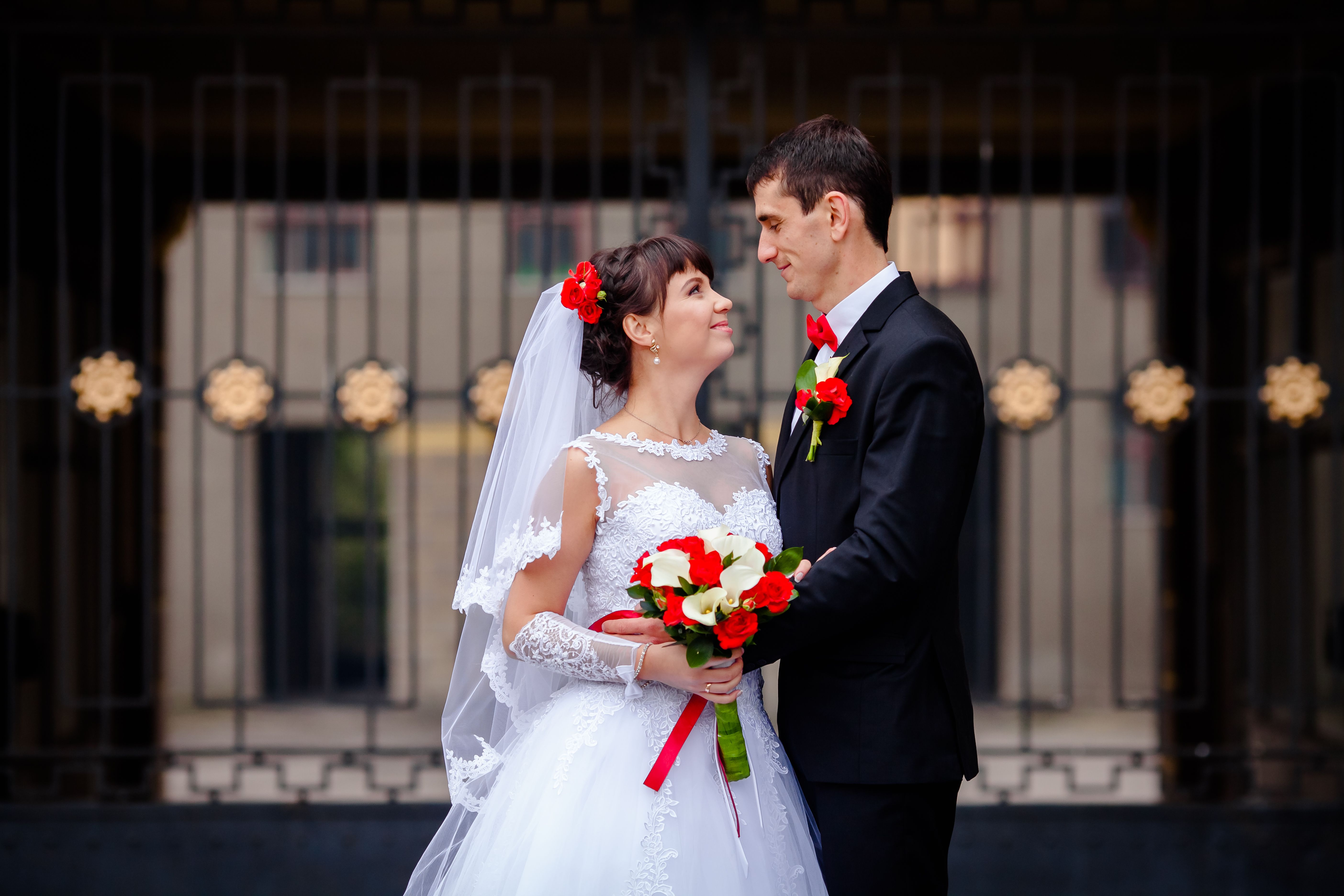 Bride and groom sharing a heartfelt moment on their wedding day, dressed in traditional attire.