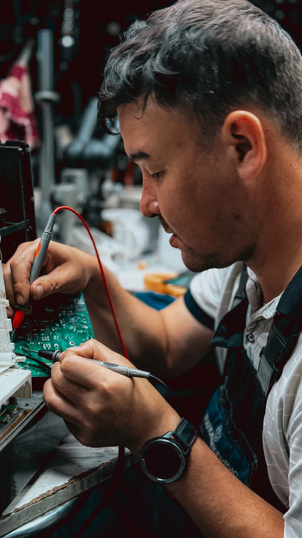Control card PCB under repair with precision tools