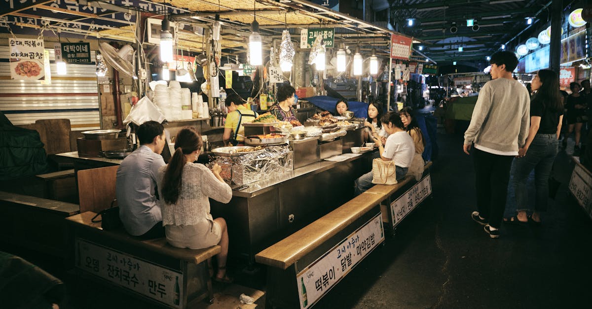Night market in Seoul bustling with people enjoying street food. A vibrant and lively atmosphere.