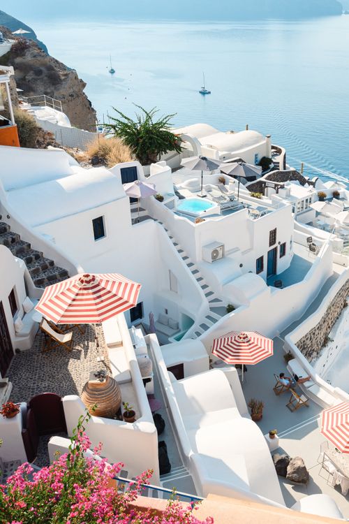 Free A stunning view of Santorini's iconic white architecture overlooking the Aegean Sea on a sunny day. Stock Photo