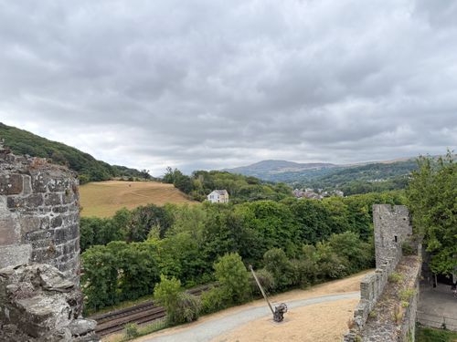 Free A picturesque view of Conwy Castle surrounded by lush greenery in Wales. Stock Photo