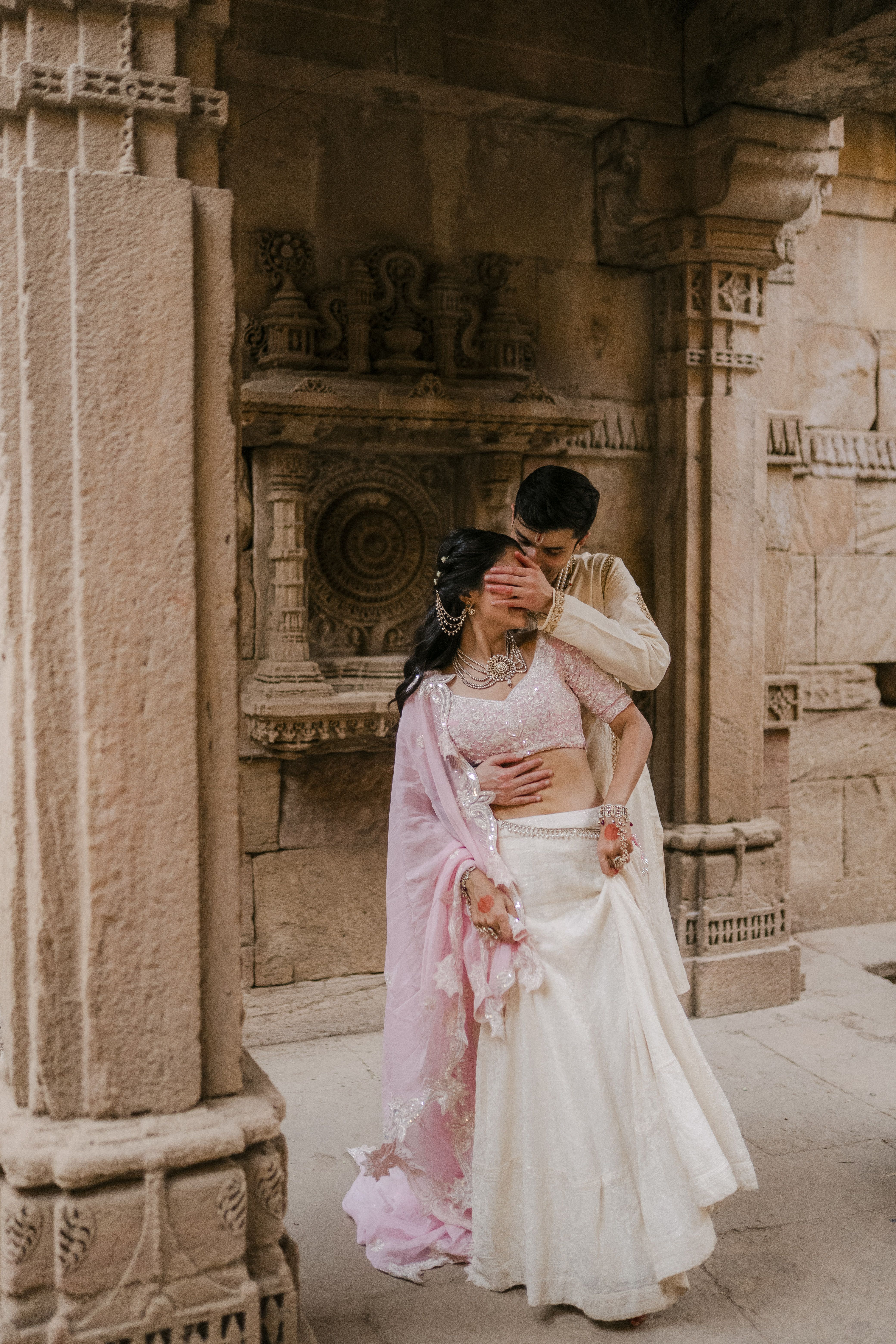 A couple embracing among old stone architecture
