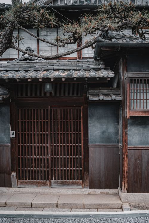 Free Traditional Japanese wooden building facade with detailed latticework in Kyoto, Japan. Stock Photo