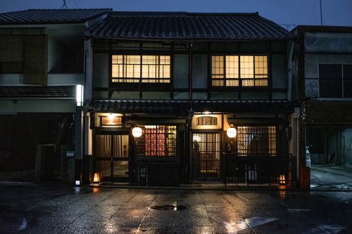 Free Beautiful illuminated traditional Japanese house in Kyoto at night, showcasing warm ambiance and unique architecture. Stock Photo