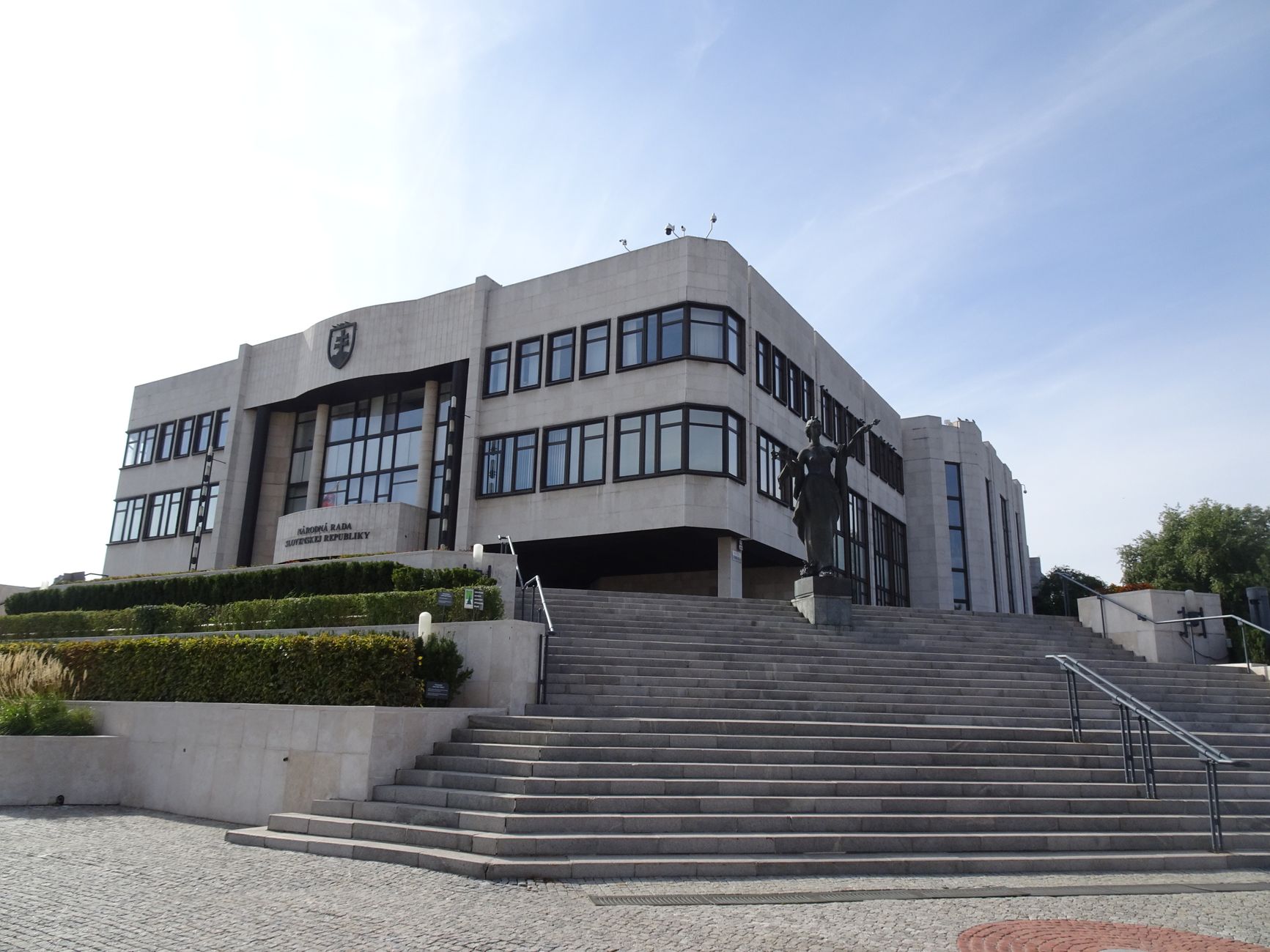 The modern Slovakian Parliament building in Bratislava, viewed from the front stairs on a sunny day.