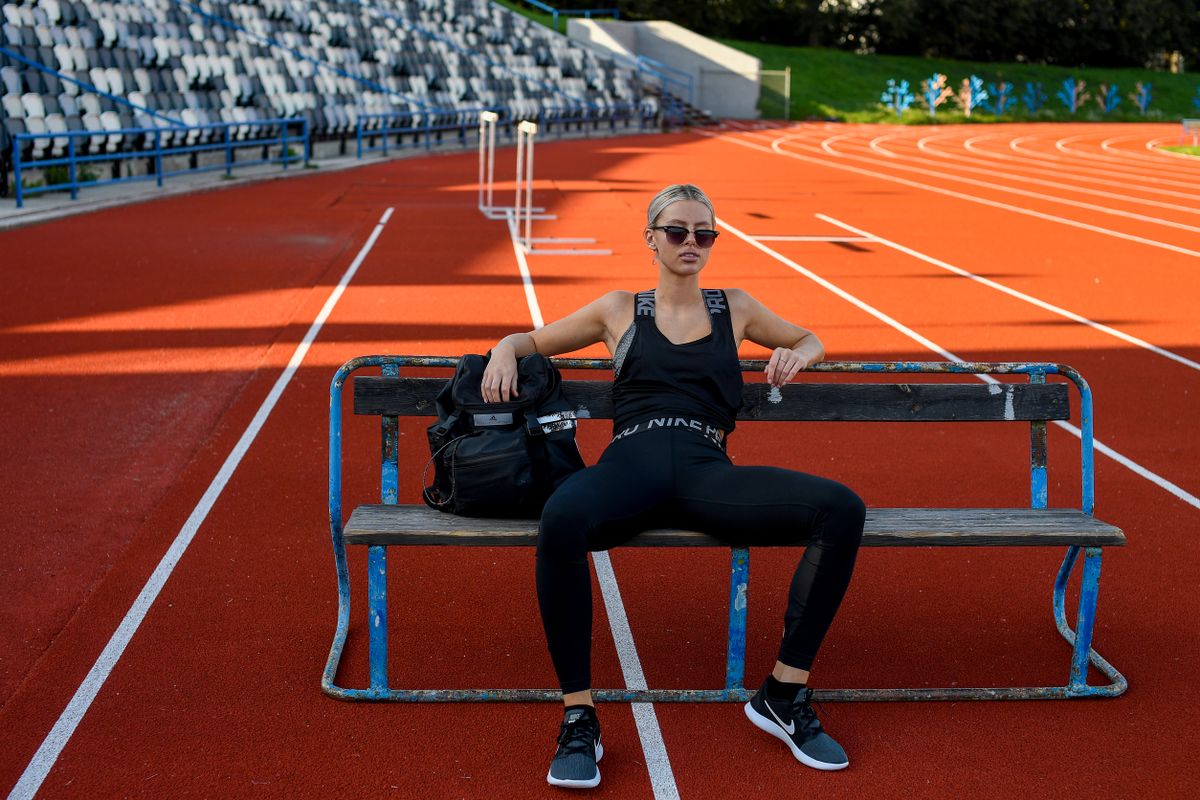Athletic woman wearing modern activewear at an outdoor running track