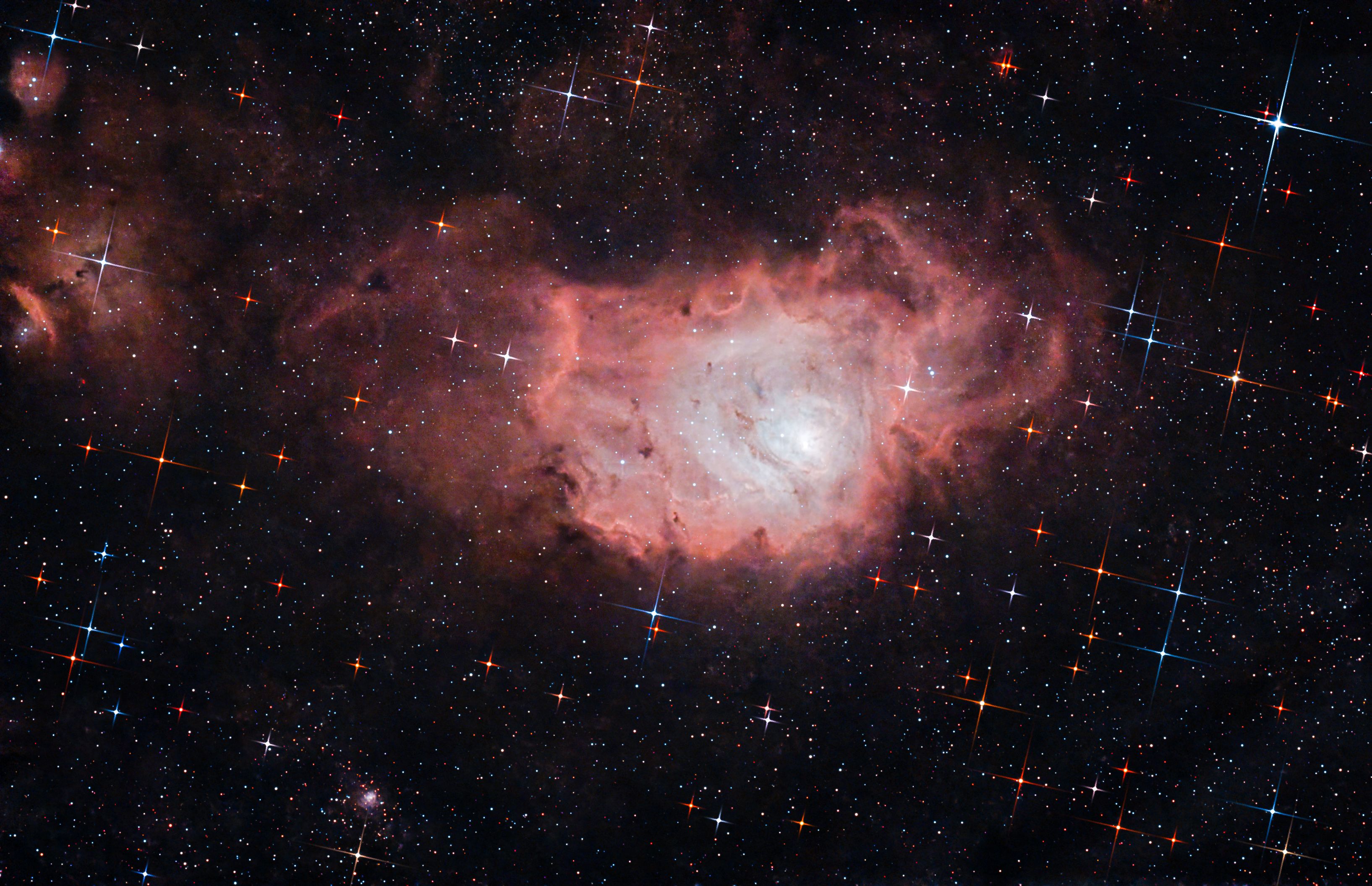 Explore the breathtaking beauty of the Lagoon Nebula with vibrant cosmic colors and star patterns.