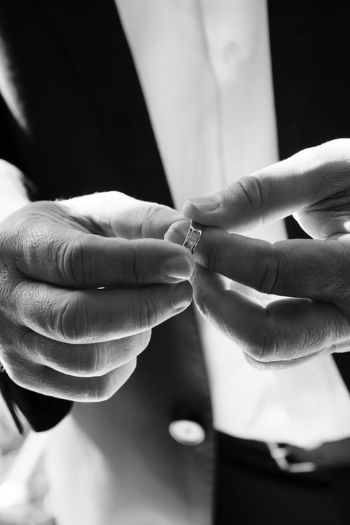 Free Elegant black and white close-up of hands holding a ring, perfect for wedding themes. Stock Photo