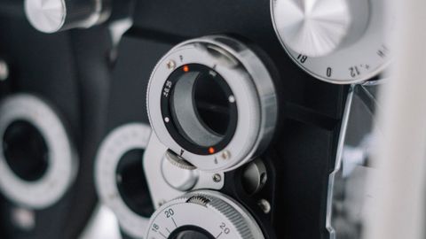 Detailed view of an optometry phoropter used for eye exams and vision tests.